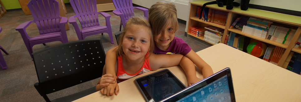 Two female students on iPads